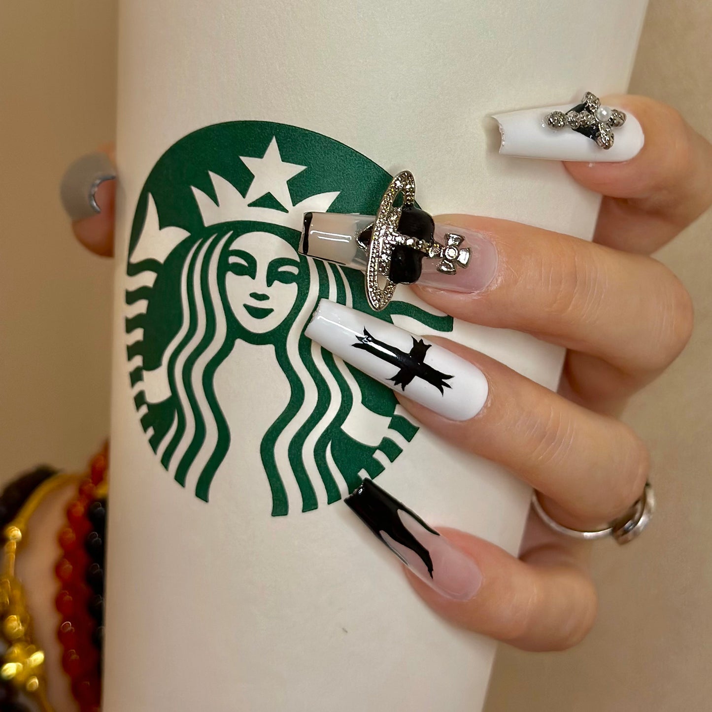 Punk girls' cross flame manicure in black white silvery painted nails