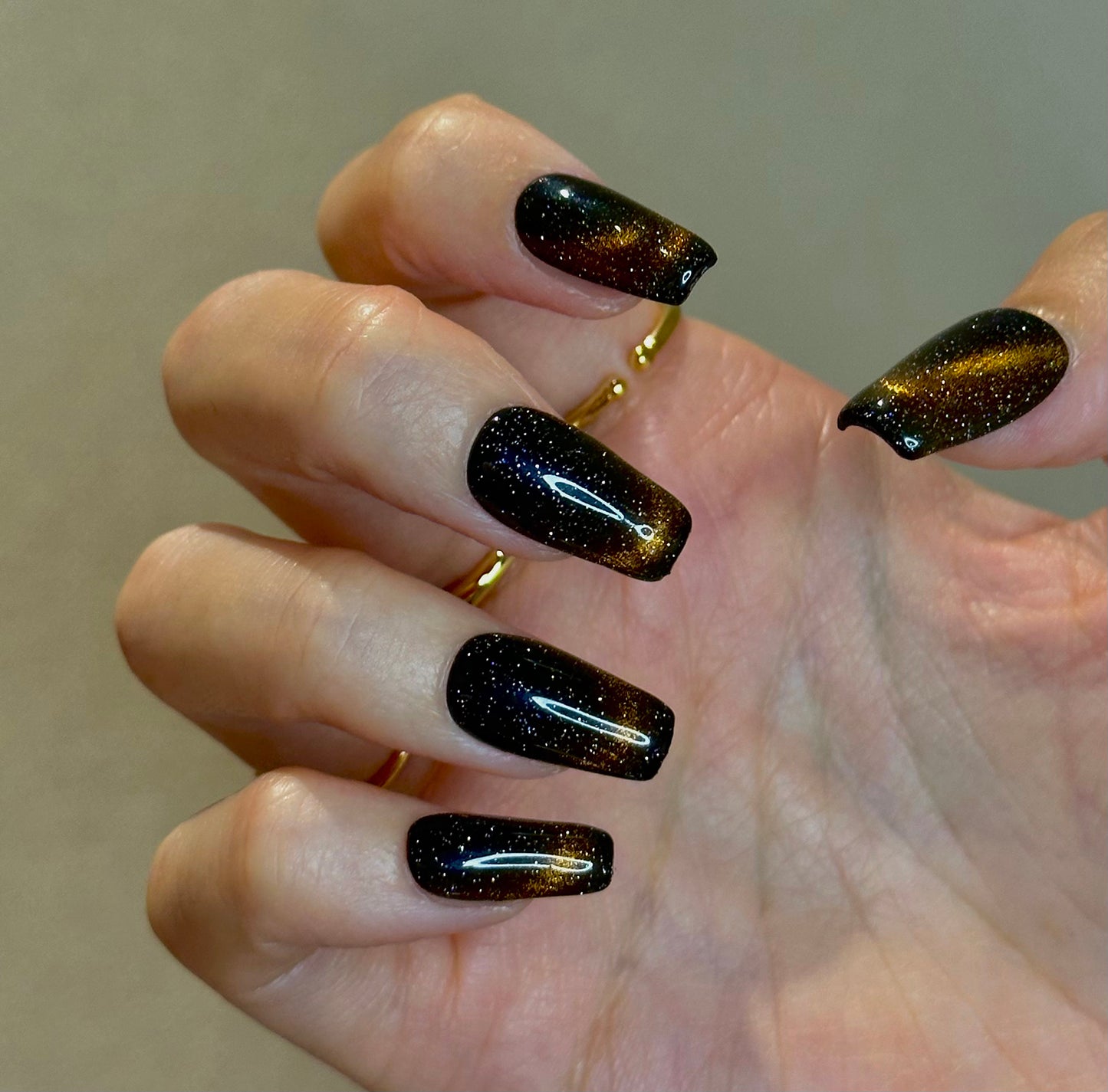 Cat eye black-brown meteor polar lights in dark sky manicure