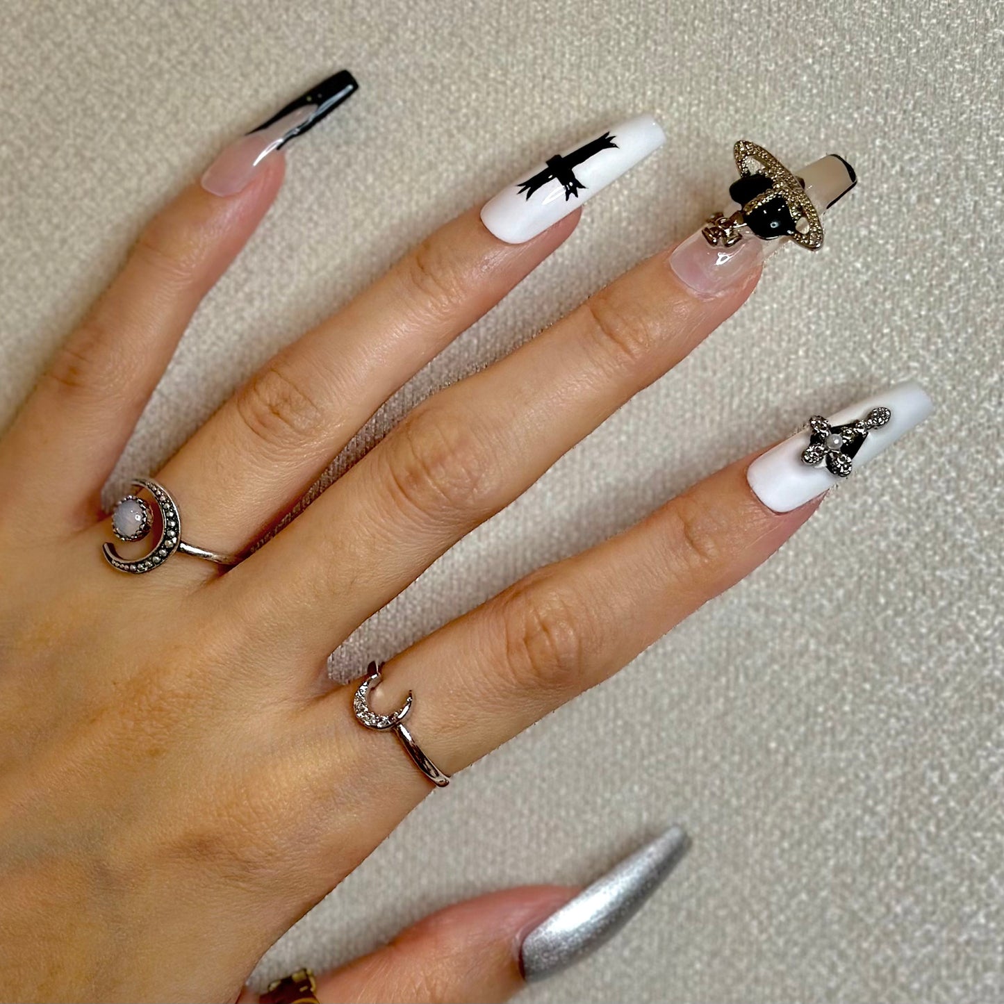 Punk girls' cross flame manicure in black white silvery painted nails