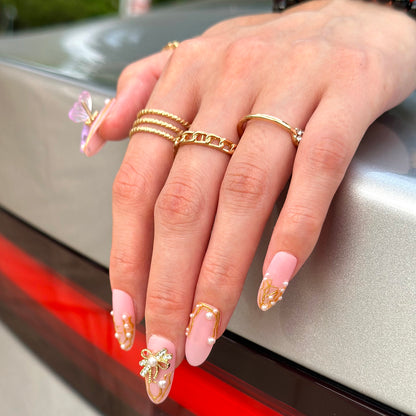 3D butterfly and pearls in elegant pink matte manicure