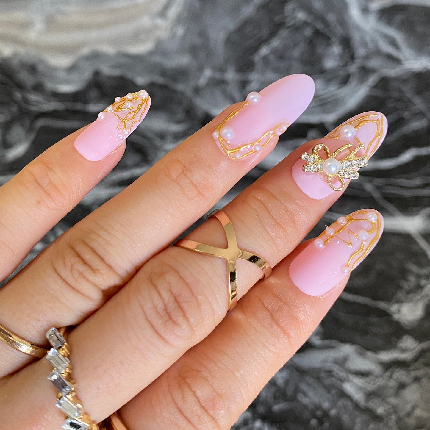 3D butterfly and pearls in elegant pink matte manicure