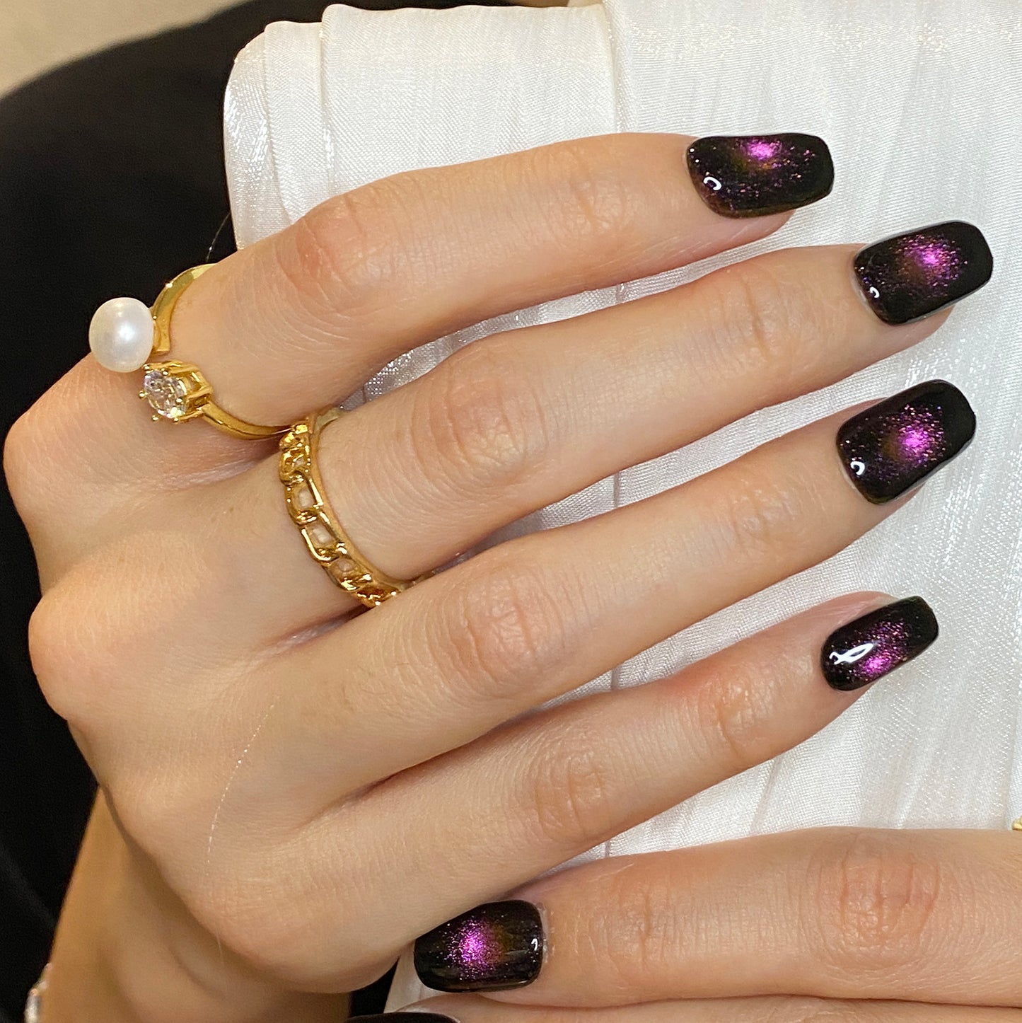 Cat eye fireworks in dark black purple-pink shiny nails